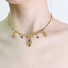 Collar dorado con dijes de mano de fatima y ojo turco