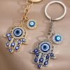 Llavero dorado diseno mano de fatima y ojo turco