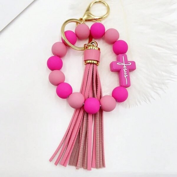 Llavero de piedras azules con cruz color rosa